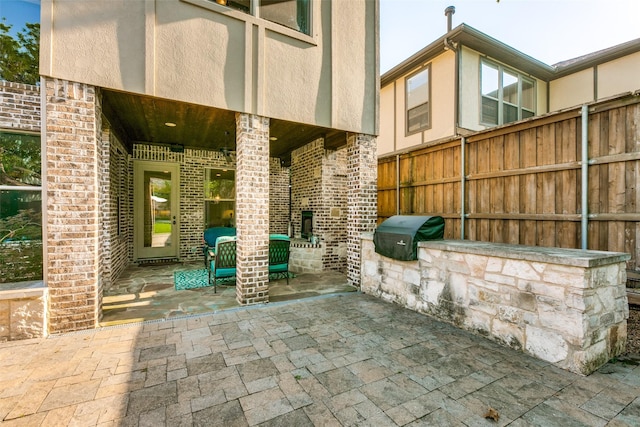 view of patio / terrace featuring a grill and fence