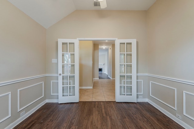 12113 Tacoma Ridge Dr, Fort Worth, TX 76244 - unfurnished room with french doors, wood finished floors, lofted ceiling, and a fireplace