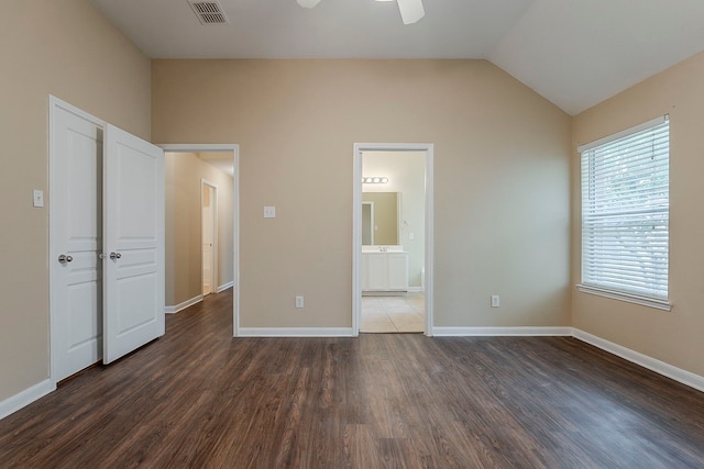 12113 Tacoma Ridge Dr, Fort Worth, TX 76244 - unfurnished bedroom featuring dark wood-type flooring, vaulted ceiling, baseboards, connected bathroom, and a ceiling fan