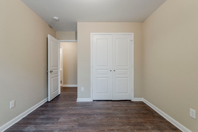 12113 Tacoma Ridge Dr, Fort Worth, TX 76244 - unfurnished bedroom with dark wood-style flooring, a closet, and baseboards