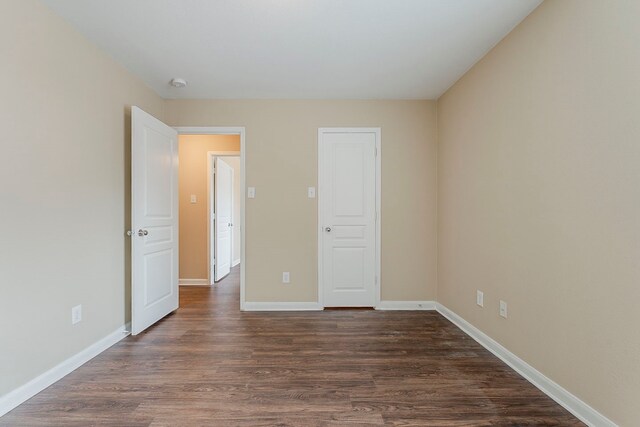 12113 Tacoma Ridge Dr, Fort Worth, TX 76244 - unfurnished bedroom with dark wood-type flooring and baseboards