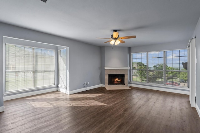 154 Henry M Chandler Dr, Rockwall, TX 75032 - unfurnished living room with baseboards, dark wood finished floors, and a tiled fireplace