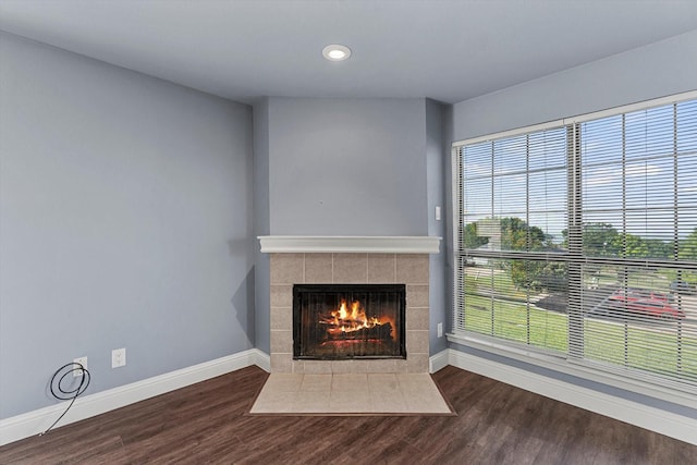 154 Henry M Chandler Dr, Rockwall, TX 75032 - unfurnished living room with baseboards, a tiled fireplace, wood finished floors, and recessed lighting