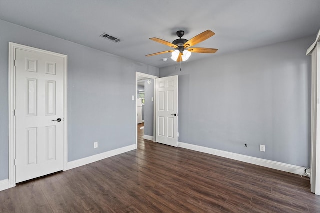 154 Henry M Chandler Dr, Rockwall, TX 75032 - unfurnished bedroom with dark wood-type flooring, baseboards, and ceiling fan