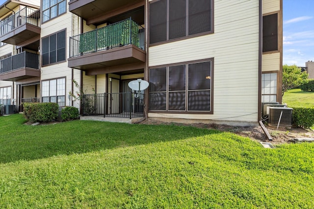 154 Henry M Chandler Dr, Rockwall, TX 75032 - rear view of property with central air condition unit and a yard