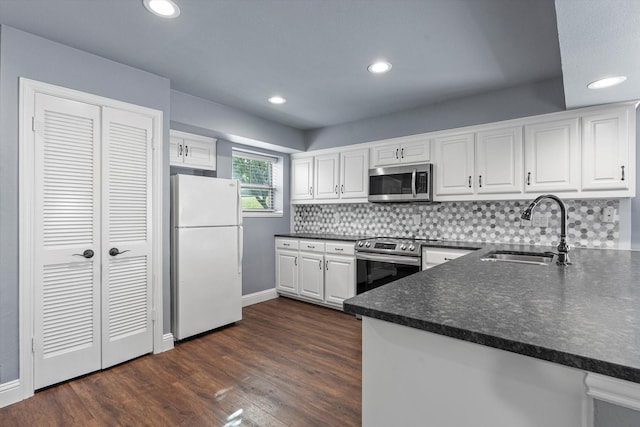154 Henry M Chandler Dr, Rockwall, TX 75032 - kitchen with stainless steel appliances, a sink, dark countertops, white cabinetry, and tasteful backsplash