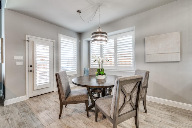 1912 Sunny Side Dr, Little Elm, TX 75068 - dining room featuring light wood-style flooring, baseboards, and a chandelier