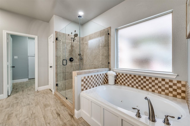 1912 Sunny Side Dr, Little Elm, TX 75068 - full bath featuring a stall shower, a tub with jets, and baseboards