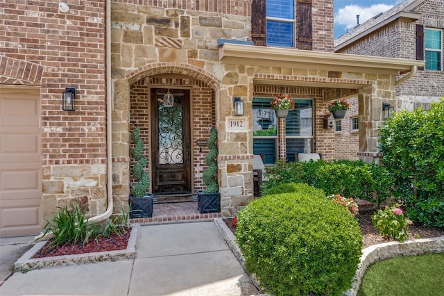 1912 Sunny Side Dr, Little Elm, TX 75068 - entrance to property with stone siding, brick siding, and covered porch