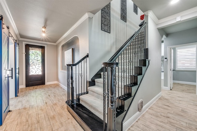 1912 Sunny Side Dr, Little Elm, TX 75068 - foyer entrance featuring wood finished floors, stairs, crown molding, and baseboards
