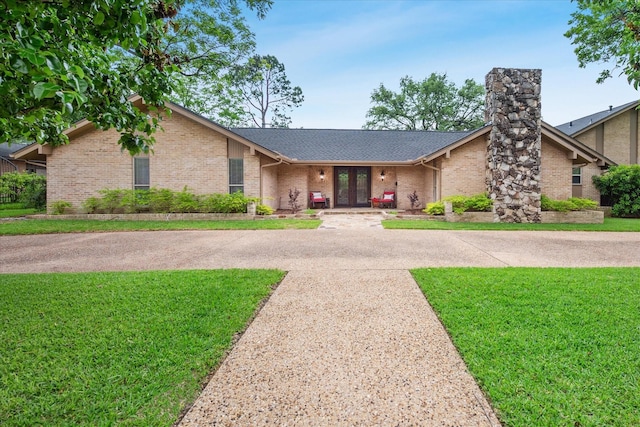 4322 Glenaire Dr, Dallas, TX 75229 - mid-century inspired home featuring french doors, a front lawn, brick siding, and a shingled roof
