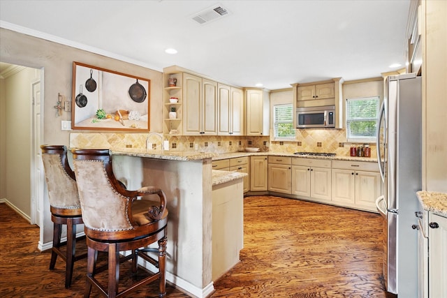 4322 Glenaire Dr, Dallas, TX 75229 - kitchen with appliances with stainless steel finishes, crown molding, light wood finished floors, a peninsula, and a kitchen bar