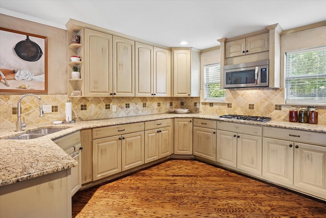 4322 Glenaire Dr, Dallas, TX 75229 - kitchen featuring appliances with stainless steel finishes, a sink, healthy amount of natural light, ornamental molding, and dark wood-type flooring