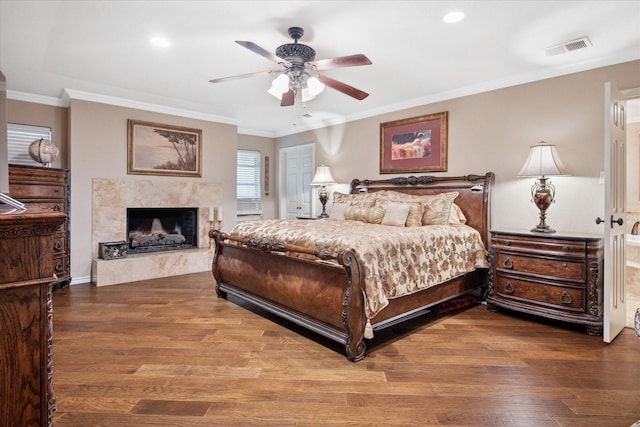 4322 Glenaire Dr, Dallas, TX 75229 - bedroom featuring wood finished floors, a fireplace, crown molding, a ceiling fan, and recessed lighting
