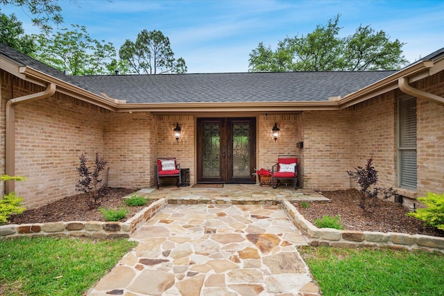 4322 Glenaire Dr, Dallas, TX 75229 - property entrance with french doors, a shingled roof, and brick siding