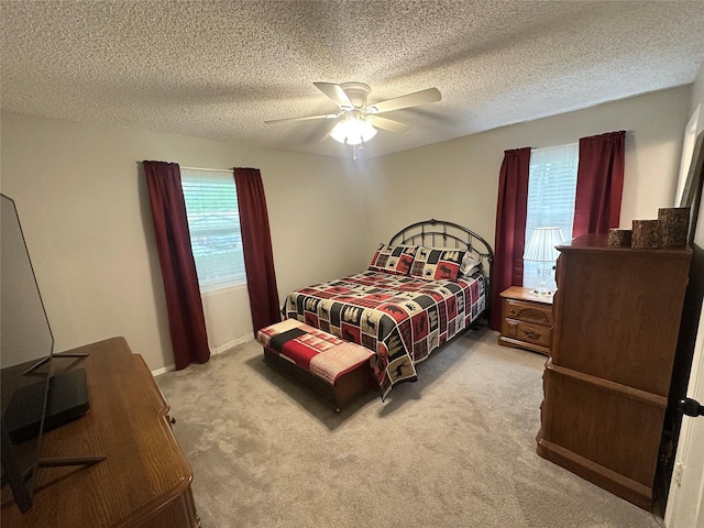 922 S Valentine Dr, Sherman, TX 75090 - bedroom featuring carpet flooring, ceiling fan, and a textured ceiling