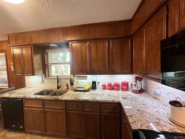922 S Valentine Dr, Sherman, TX 75090 - kitchen featuring black dishwasher, a sink, tasteful backsplash, a textured ceiling, and wood walls