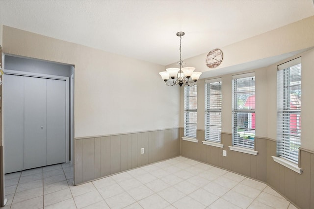 7108 Stonybrooke Dr, North Richland Hills, TX 76182 - unfurnished dining area featuring wainscoting, a chandelier, and wood walls