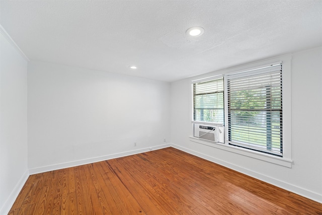 306 N Bordon St, Lorena, TX 76655 - spare room featuring cooling unit, baseboards, wood finished floors, and recessed lighting