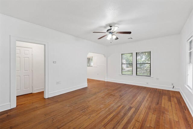 306 N Bordon St, Lorena, TX 76655 - unfurnished room featuring a ceiling fan, hardwood / wood-style floors, baseboards, and arched walkways