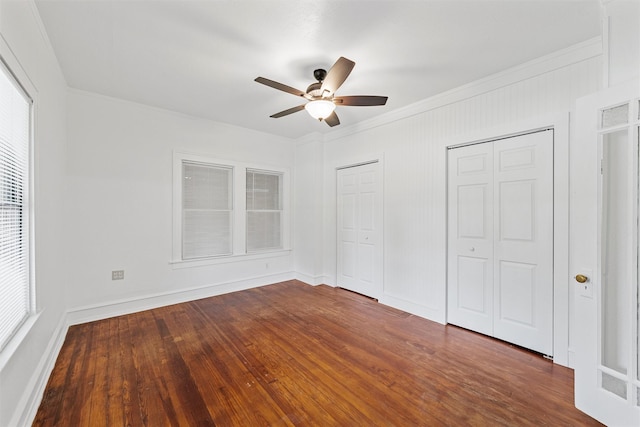 306 N Bordon St, Lorena, TX 76655 - unfurnished bedroom featuring two closets, ornamental molding, dark wood-style flooring, baseboards, and ceiling fan
