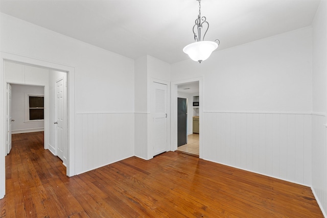 306 N Bordon St, Lorena, TX 76655 - unfurnished room with a wainscoted wall, hardwood / wood-style flooring, and crown molding