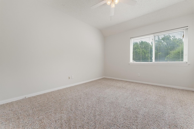 carpeted empty room with a ceiling fan, baseboards, a textured ceiling, and lofted ceiling
