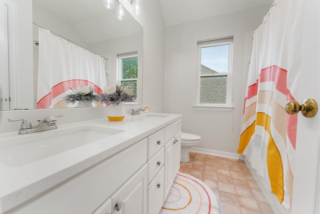bathroom featuring baseboards, toilet, double vanity, and a shower with shower curtain