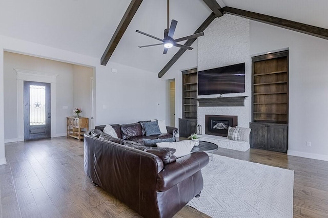 2720 Creek Crossing Ln, Midlothian, TX 76065 - living area featuring a ceiling fan, baseboards, wood finished floors, beamed ceiling, and a large fireplace