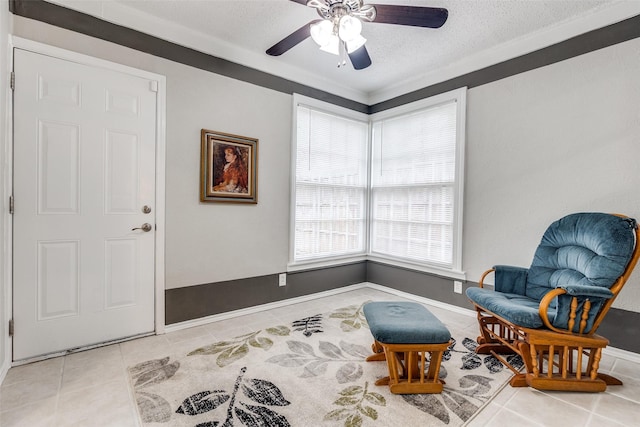 2614 Ivandell Ave, Dallas, TX 75211 - sitting room featuring tile patterned flooring, a textured ceiling, a ceiling fan, and baseboards