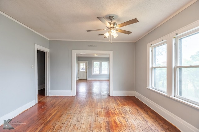 1810 Merchant St, Abilene, TX 79603 - unfurnished room with ornamental molding, light wood-style floors, a ceiling fan, baseboards, and a textured ceiling