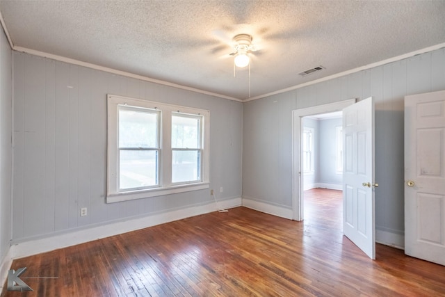 1810 Merchant St, Abilene, TX 79603 - unfurnished room with hardwood / wood-style floors, a textured ceiling, crown molding, baseboards, and a ceiling fan