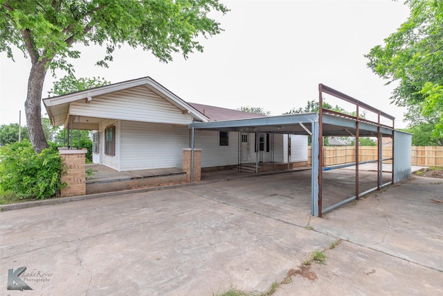1810 Merchant St, Abilene, TX 79603 - view of front of home featuring an attached carport, fence, and driveway