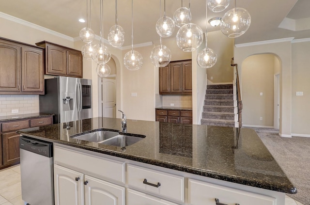 205 Mineral Point Dr, Aledo, TX 76008 - kitchen featuring arched walkways, stainless steel appliances, a sink, dark stone countertops, and backsplash