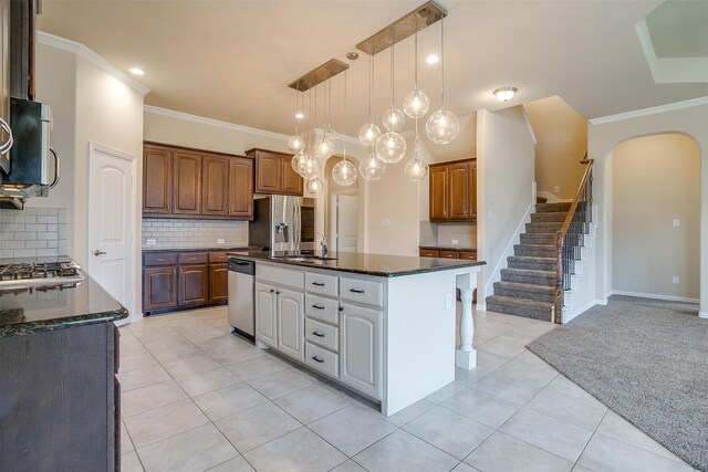 205 Mineral Point Dr, Aledo, TX 76008 - kitchen featuring ornamental molding, arched walkways, appliances with stainless steel finishes, light tile patterned flooring, and tasteful backsplash