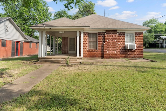 2701 Ethel Ave, Waco, TX 76707 - view of front of home featuring brick siding, a front lawn, roof with shingles, and covered porch
