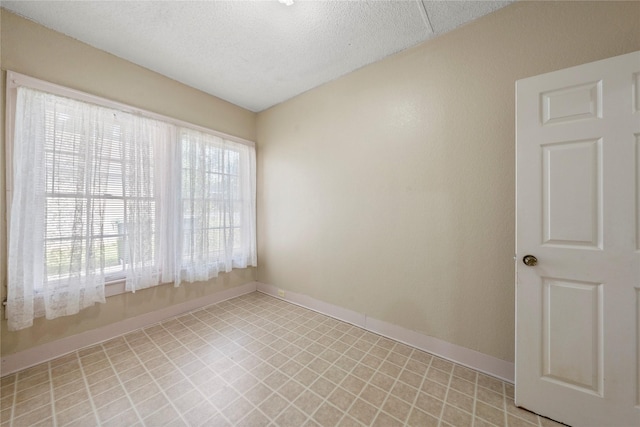 2701 Ethel Ave, Waco, TX 76707 - unfurnished room with baseboards, light flooring, and a textured ceiling