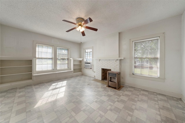 2701 Ethel Ave, Waco, TX 76707 - unfurnished living room featuring a ceiling fan, a textured ceiling, heating unit, light floors, and baseboards