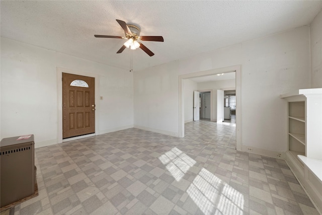 2701 Ethel Ave, Waco, TX 76707 - spare room featuring ceiling fan, a textured ceiling, baseboards, and radiator