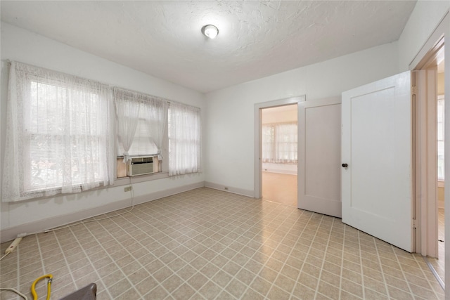 2701 Ethel Ave, Waco, TX 76707 - spare room with plenty of natural light, light floors, cooling unit, and baseboards