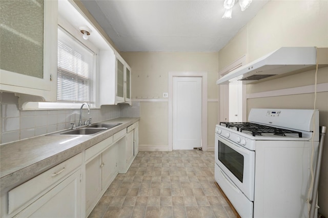 2701 Ethel Ave, Waco, TX 76707 - kitchen with gas range gas stove, a sink, tasteful backsplash, glass insert cabinets, and white cabinets