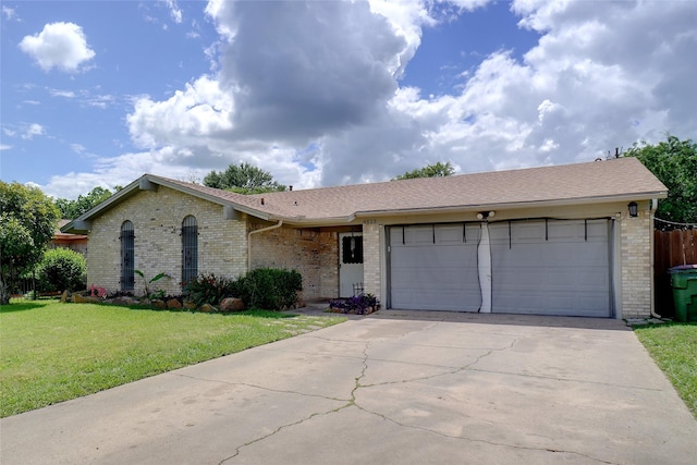 single story home featuring brick siding, concrete driveway, an attached garage, a front yard, and a shingled roof