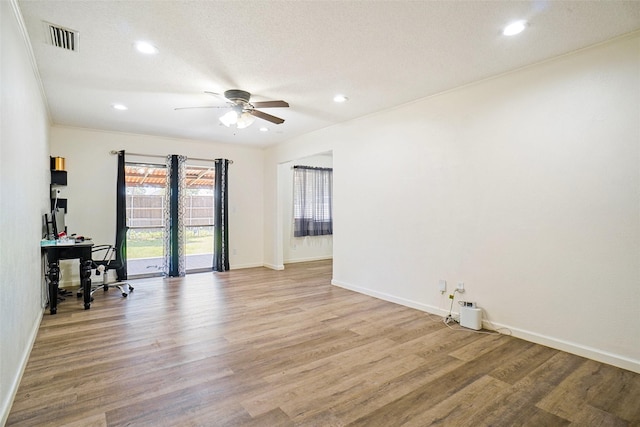 empty room featuring a ceiling fan, a desk, light wood-type flooring, baseboards, and recessed lighting
