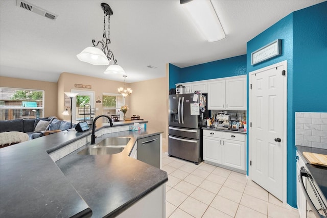 836 Heberle Dr, Burleson, TX 76028 - kitchen with stainless steel appliances, a sink, dark countertops, and light tile patterned floors