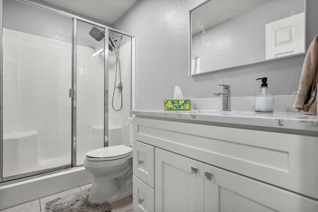 836 Heberle Dr, Burleson, TX 76028 - bathroom featuring a textured wall, toilet, vanity, a stall shower, and tile patterned flooring