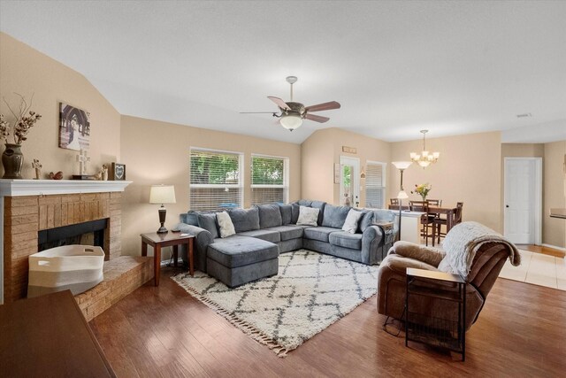836 Heberle Dr, Burleson, TX 76028 - living area featuring a chandelier, ceiling fan, wood finished floors, and a fireplace
