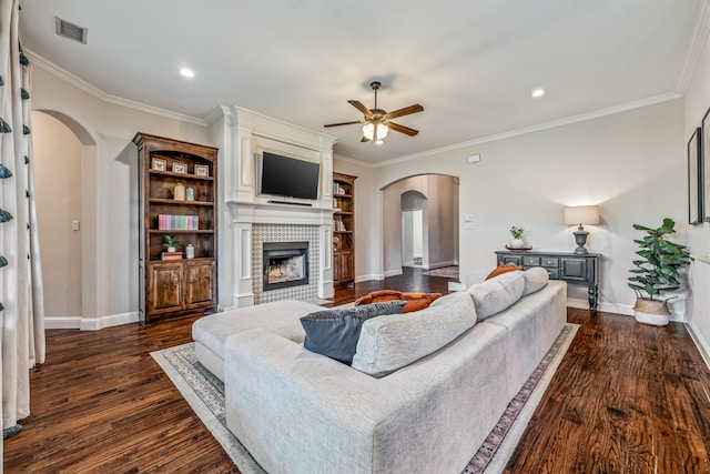 437 Sagebrush Dr, Aledo, TX 76008 - living room with arched walkways, ceiling fan, dark wood-style flooring, a tile fireplace, and baseboards