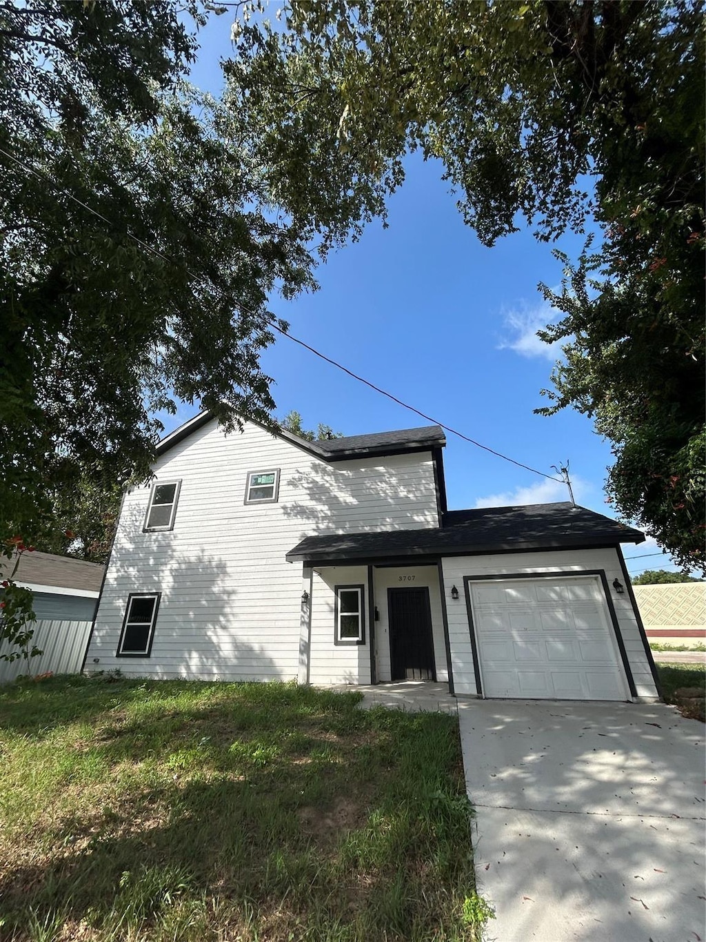 3707 Spence St, Dallas, TX 75215 - traditional home with a garage, driveway, and a front yard