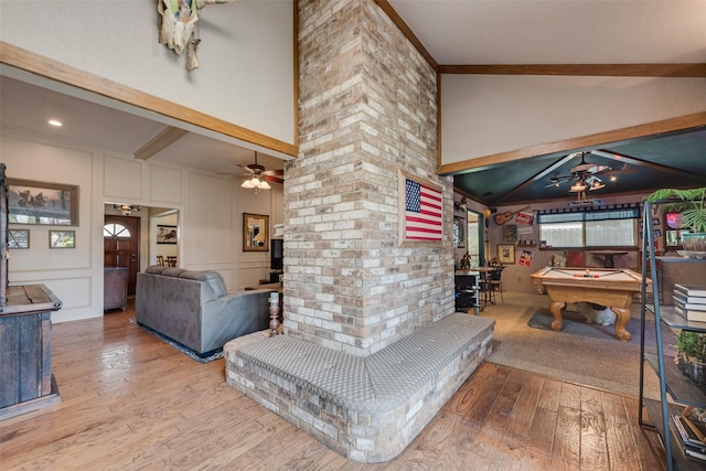 rec room featuring a ceiling fan, wood finished floors, billiards, a decorative wall, and crown molding