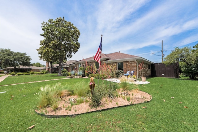 view of front facade featuring a front lawn and brick siding